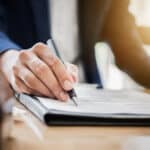man reviewing 481a adjustment papers with pen