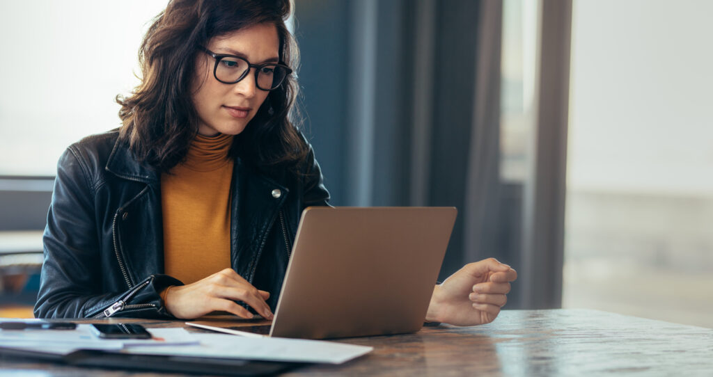 woman working on state and local taxes on laptop