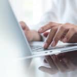 person working on sales tax nexus on laptop