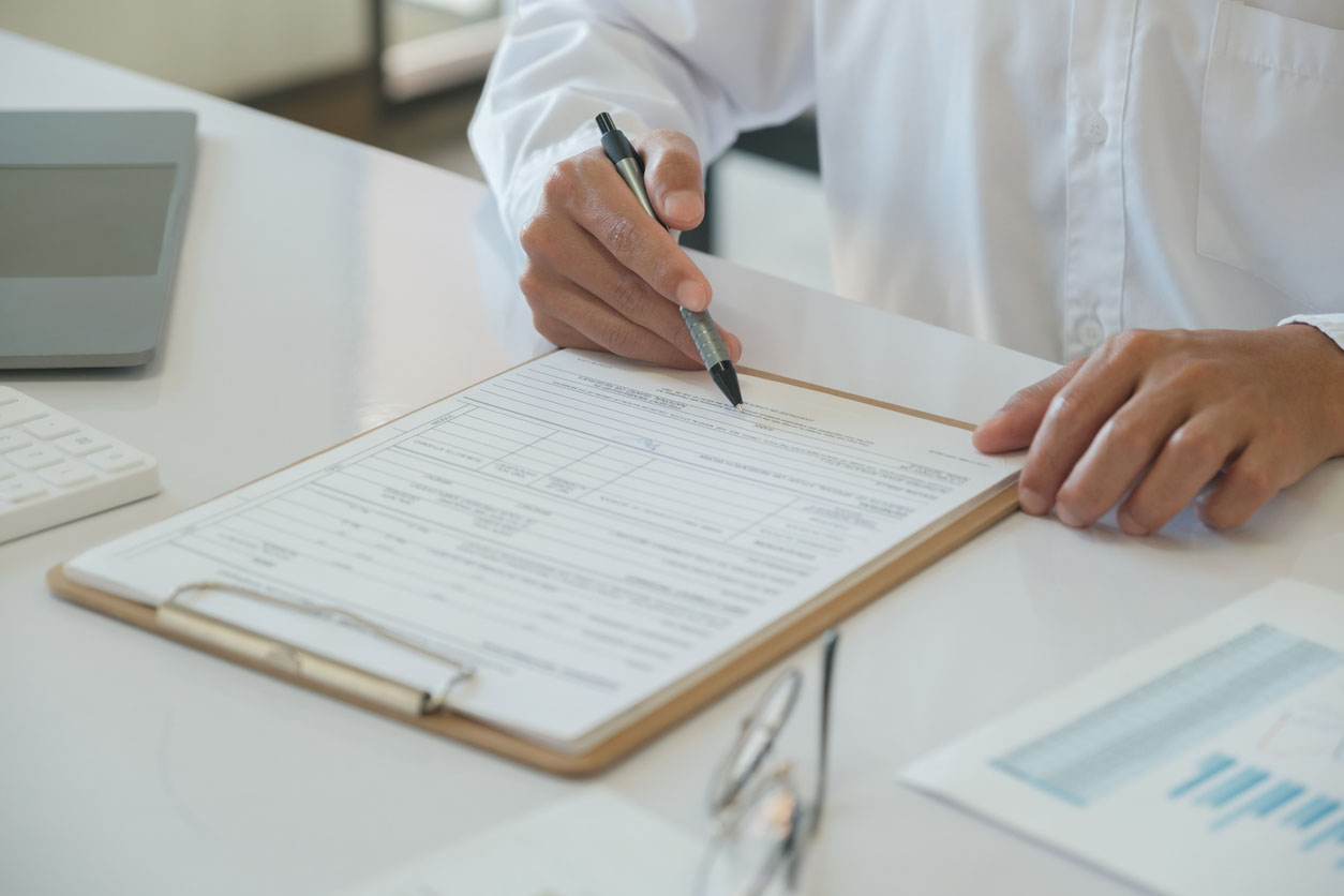 Person filling out form 8908 at desk